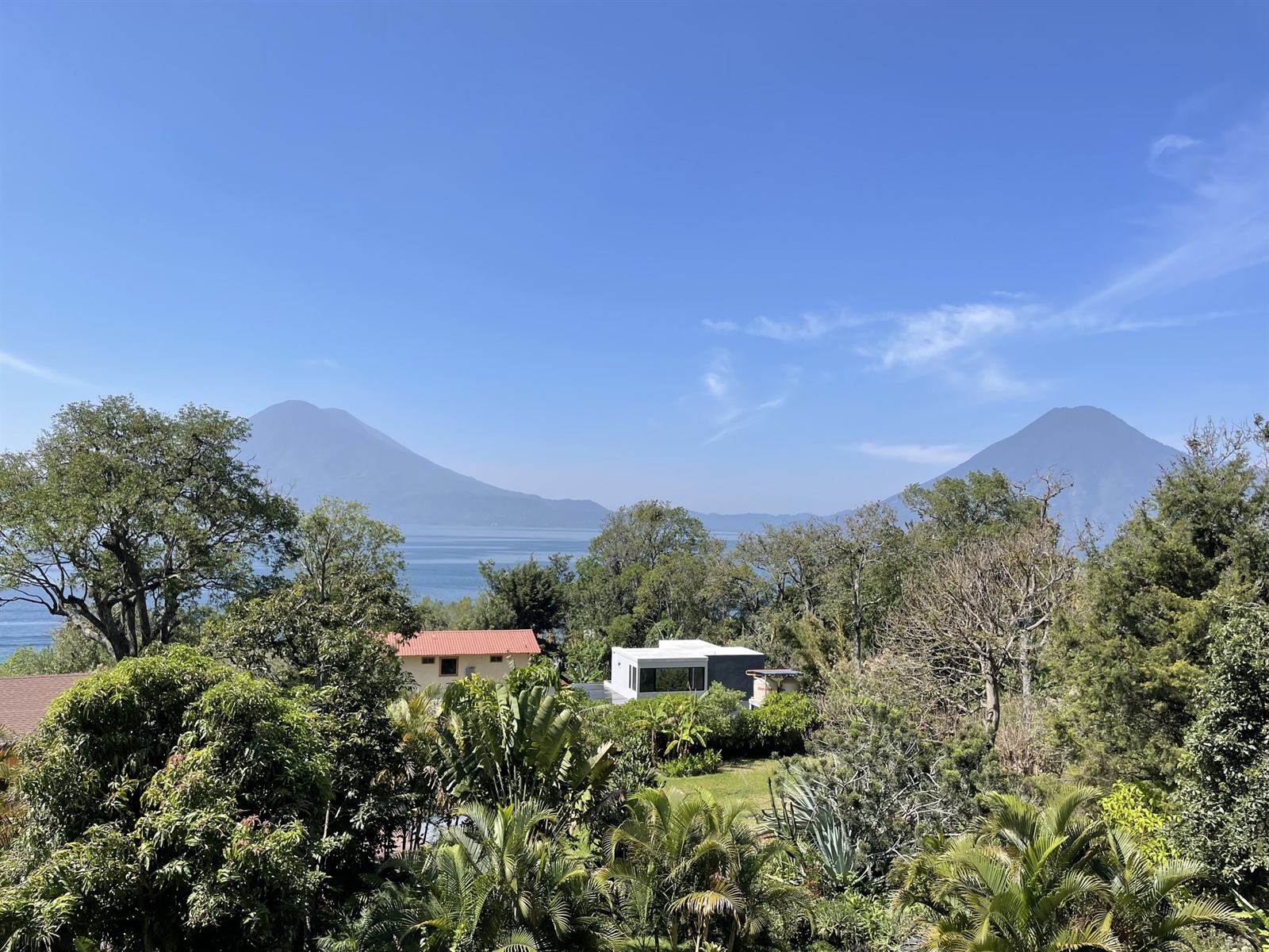 View from the villa terrace over the tropical garden to Lake Atitlán and its volcanoes